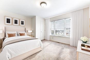 A bedroom with a large bed and a large window
